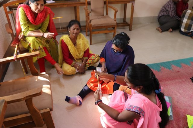 Teachers measuring heat by thermometer  