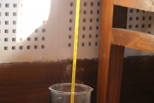 Measuring the temperature of hot water.